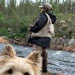 Wheaton Cairn with owner who is fishing